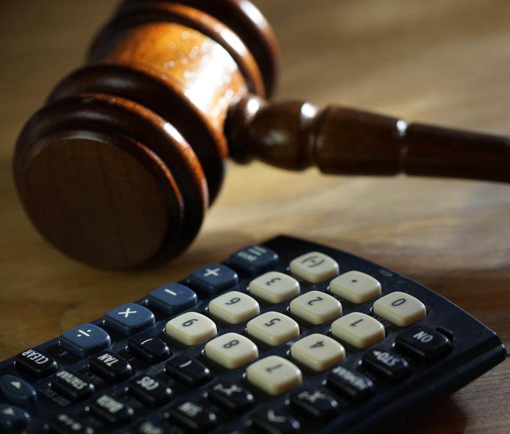 A lawyer uses a calculator representing the idea of personal injury calculator